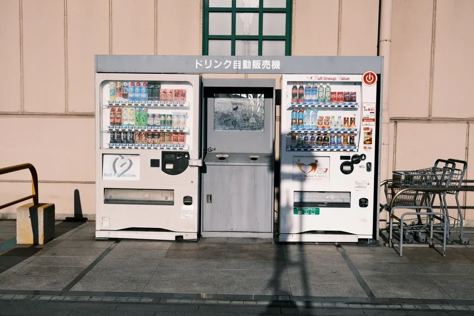 Vending machines in Gamagōri, Japan offer diverse drinks in a city setting.