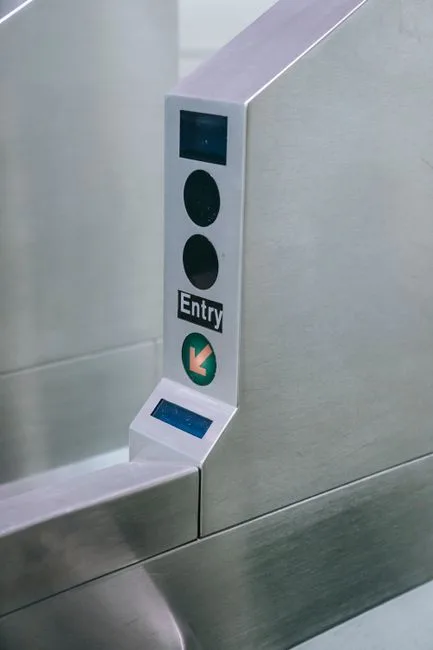 Close-up of a metro station entry gate with scanner and directional arrow.