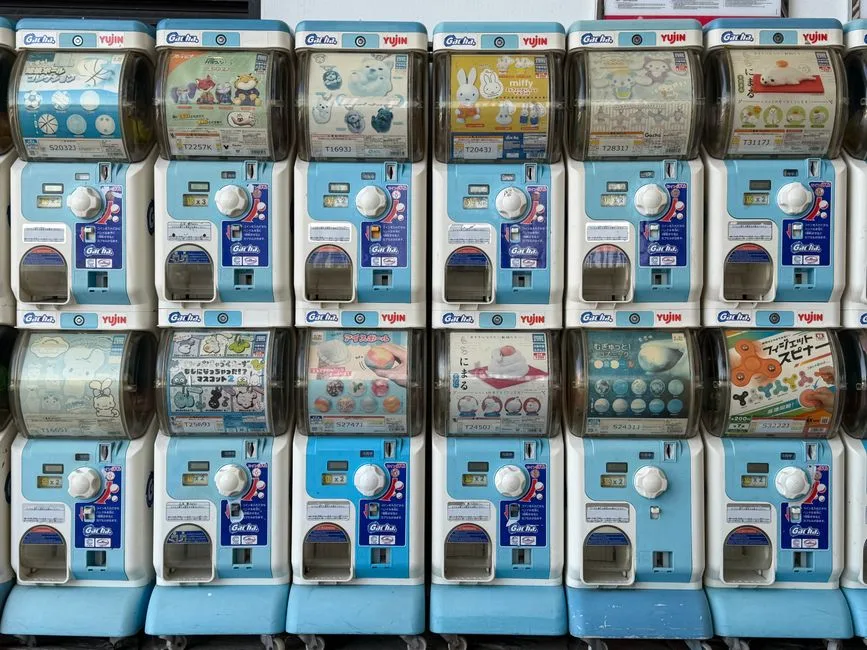Colorful gashapon vending machines display toys and collectibles in Hong Kong.