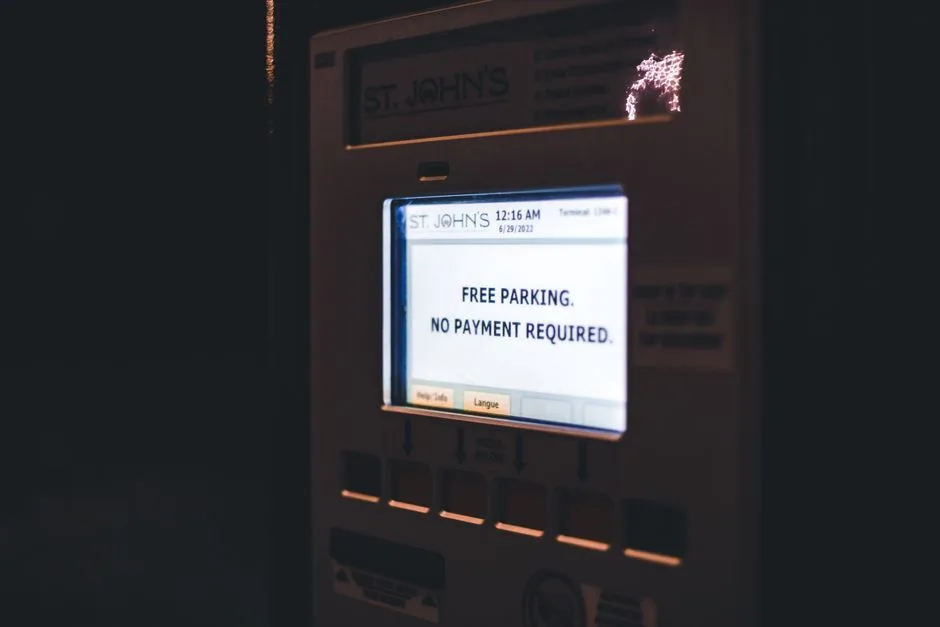 Illuminated digital display offering free parking at St. John's during nighttime.
