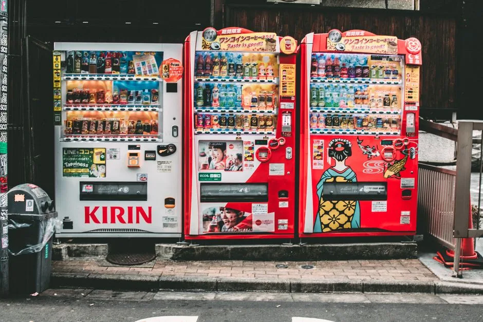 Vibrant vending machines in Tokyo offering a variety of drinks on a bustling street.