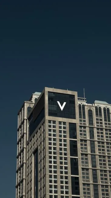 Close-up view of a modern skyscraper facade in Dubai with clear sky background.