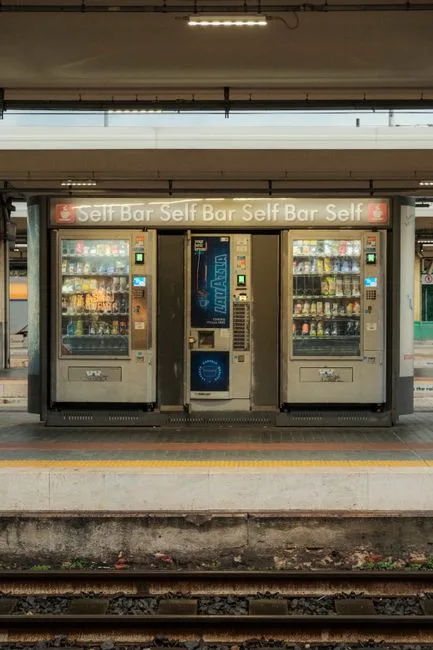 Vending machines on a train platform offering snacks and drinks.